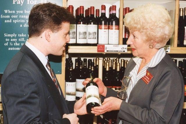 Gareth Morgan and Vera Williams discuss wine in the busy drinks department at Marks and Spencer during Christmas 1993