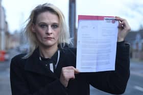 Scarlet Willcock with a letter from Lancashire County Council informing her that she has been banned from entering Eldon Primary School for "displaying aggressive and intimidating behaviour" which she denies