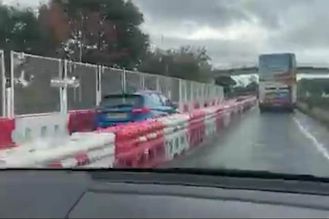 Video grab from footage showing a confused motorist cruising along a barricaded section of dual carriageway after taking a wrong turn