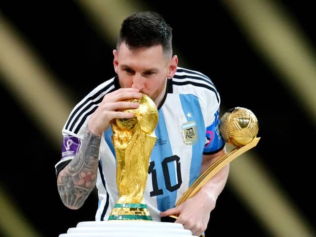 Argentina's Lionel Messi kisses the FIFA World Cup trophy after being presented with the Golden Ball award  (Nick Potts/PA Wire)