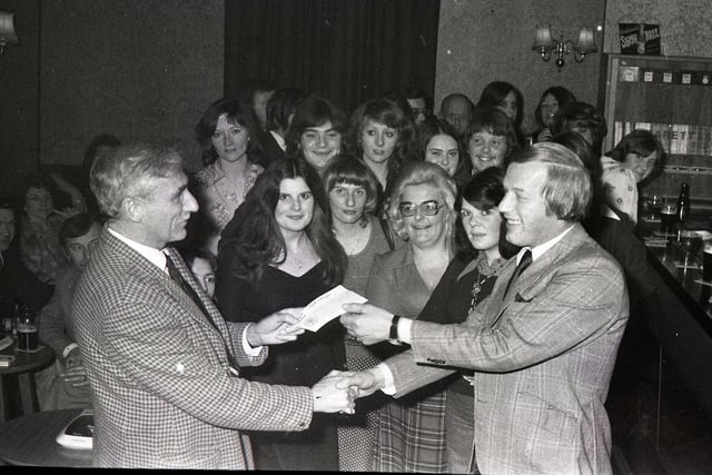 Mr Bob Smith (right), landlord at the Ribbleside Inn, Broadgate, Preston, presents a cheque for £110, the proceeds of a pram race organised by the women's darts team, to Mr Bill Margerison of the Shepherd Street Mission