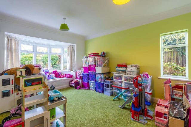 This ground-floor reception room is currently being used as a playroom. However, it could easily be converted into a formal dining room or even a second living room.