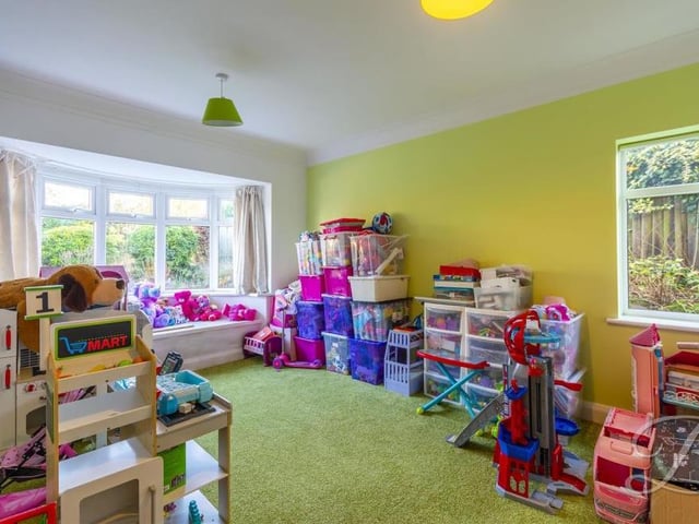 This ground-floor reception room is currently being used as a playroom. However, it could easily be converted into a formal dining room or even a second living room.