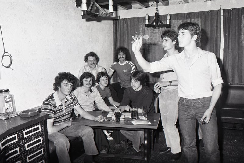 Locals at the Ram's Head Hotel, Tarleton, near Preston, threw a mammoth 56,000 darts in a three-day game, all to raise money for Muscular Dystrophy. Picture shows Trevor Stringfellow and Steven Lathom taking their turn, watched by other members of the team (from left) Derek Howarth, Graeme Iddon, Graham Rimmer, Graham Cooper, George Tiffin, Kevin Rimmer (scorer)