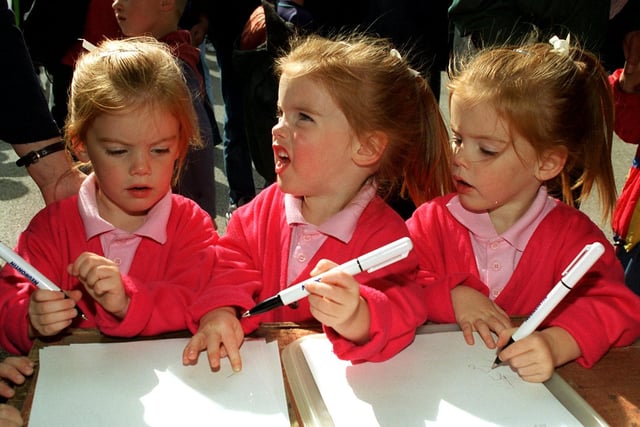 What should I write mum? Simone Brennan, centre, and her triplet sisters Rio, left and Nakita, all age three from Lea, get advice on what to write on their message of condolence at the Lea CP School balloon release in memory of Princess Diana