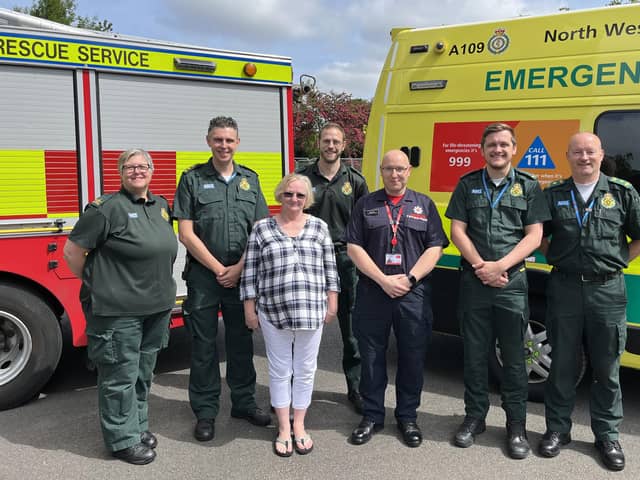 Diane Fenton with NWAS crews and community first responder Andy Dow. (Photo by Lancashire Fire & Rescue Service)