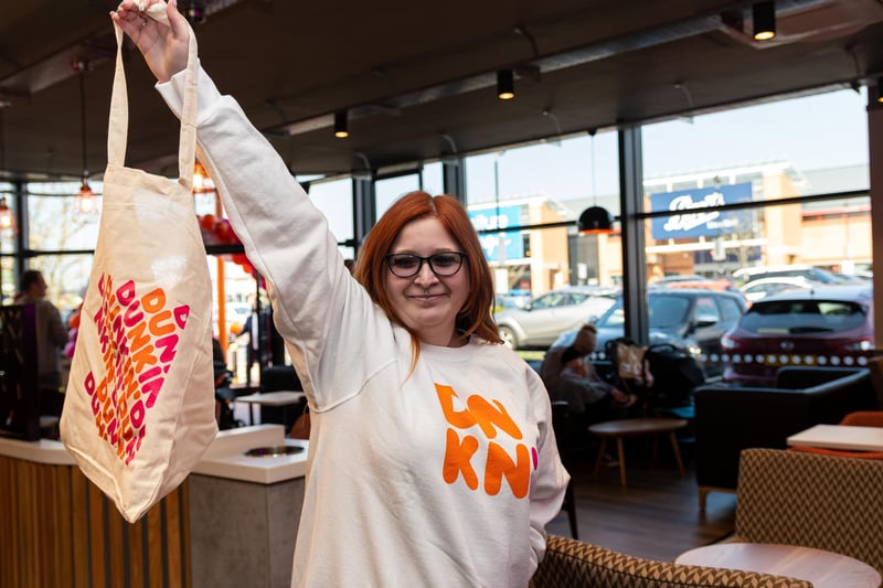 Customer Gina Mathers models her new hoodie at the opening of Dunkin Donuts at the Capitol Centre, Preston. Photo: Kelvin Stuttard