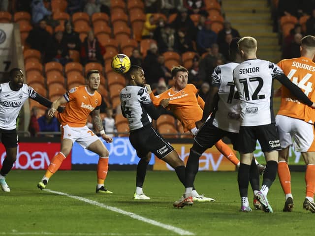 Blackpool’s Jake Beesley (centre) scores the opening goal despite the attentions of Morecambe’s Jacob Bedeau (photo: Lee Parker/CameraSport)