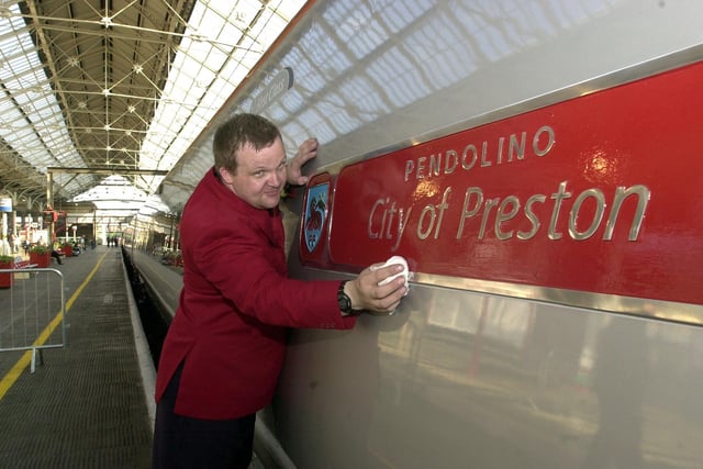 Ian Massey polishing the City of Preston train at Preston Railway Station. The train carried the Queen to Preston on her Jubilee visit