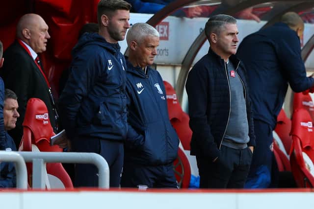 Preston North End manager Ryan Lowe watches on alongside assistant Mike Marsh (centre) and first team coach Paul Gallagher (left).