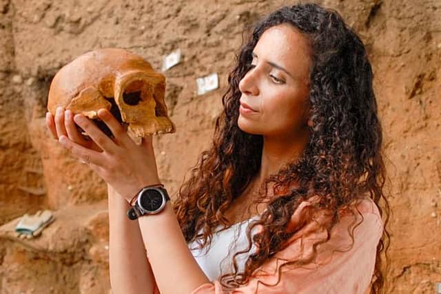 Ella Al-Shamahi holds a cast of one of the early homo sapiens skulls found at Jebel Irhoud, in Morocco, in the BBC's new series Human (Picture: BBC/BBC Studios)