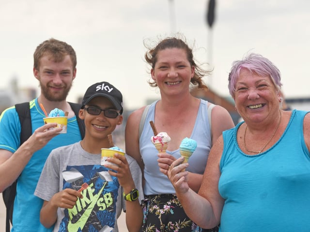 Holidaymakers and locals enjoy one of the hottest days of the year in Blackpool on July 27 2019. Adam Savage, Aaron Savage, Angela Clarke and Sylvia Savage enjoy an ice cream on Blackpool Prom.