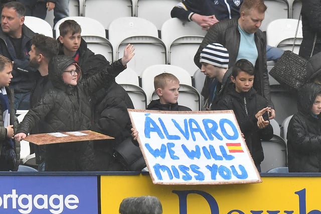 Fans with a sign at the end of the game