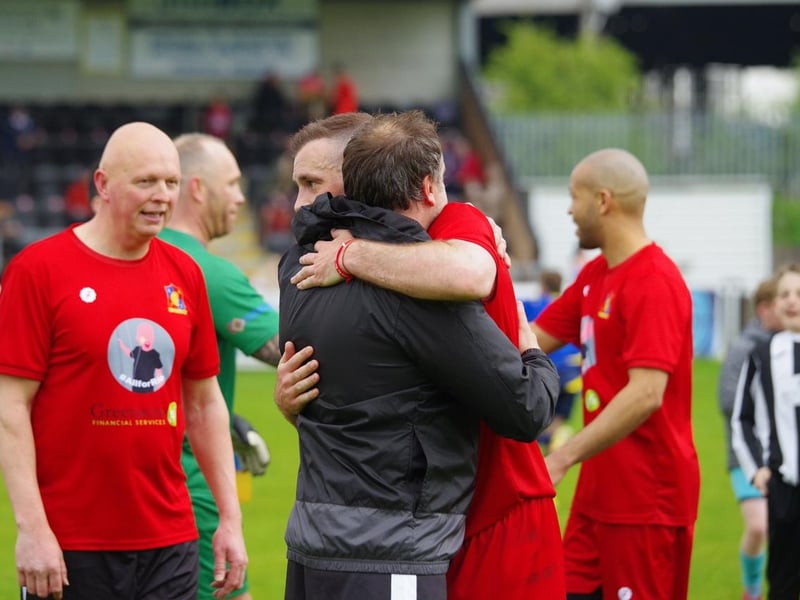 Tommy Spurr embraces one of the game's organisers, Chris Singleton
