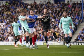 Wigan keeper Sam Tickle collects under pressure from Colby Bishop