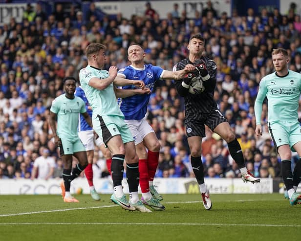 Wigan keeper Sam Tickle collects under pressure from Colby Bishop