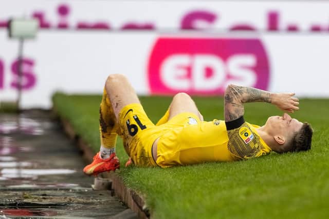 Preston North End's Emil Riis awaits treatment after colliding with an advertising board at Stoke