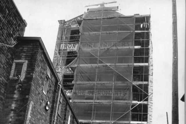 You can just about make out the old lettering for Starkies Wire Works underneath the scaffolding netting as work was underway in 1989 to redevelopment the whole of Cotton Court, on Church Street, Preston