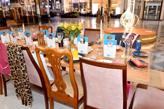 A 13-seater dining table set for dinner without guests is unveiled by national bereavement charity, Sue Ryder in Leeds - each chair features a personal item to represent a real person who has passed away, marking the start of 'The Empty Chair' campaign. Photo: Anthony Devlin/PA Wire