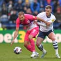 Preston North End's Liam Lindsay battles with Huddersfield Town's Jordan Rhodes