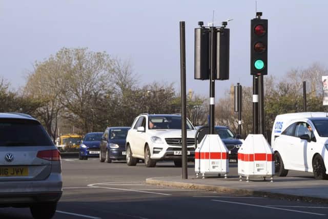 Traffic is moving smoothly, controlled by smart lights in Ringway.
