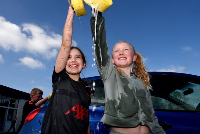 Year 4 pupils washing cars.