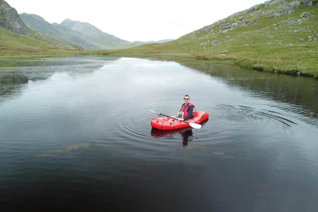 Mark Houghton sitting in his MRS Tulo packraft at Red Tarn.