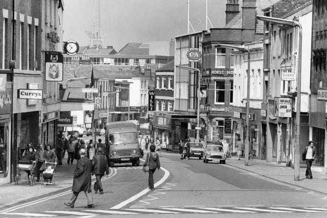 This image shows a bustling Friargate as we look towards C&A. If you were to stand in the same place today and take a photo you would still manage to capture the Black Horse pub, but all the cars would be gone