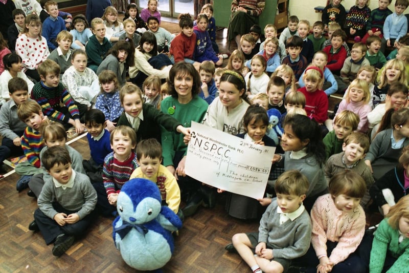 Pupils in the lower classes at Middleforth CofE School in Penwortham, near Preston, employed brain power to raise over £1,000 for the National Society for the Prevention of Cruelty to Children. Pictured: Susan Doley collects a cheqque from Rachel Abram, Stephanie Derbyshire and Ruth and Naomi Elliott