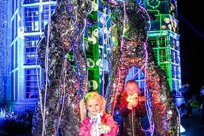 Lumens stilt-walkers, joined by some little spectators, light up Astley Illuminated