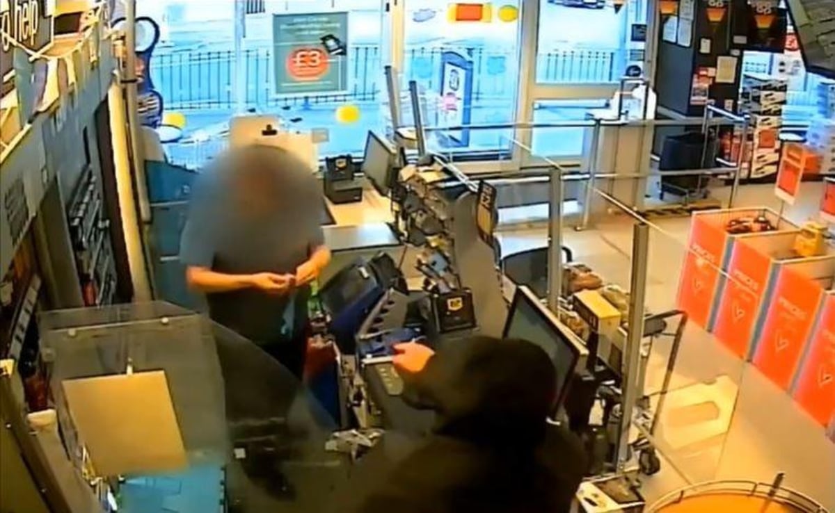 'I am going to kill you': Watch moment man armed with knife threatens staff member after forcing his way behind counter