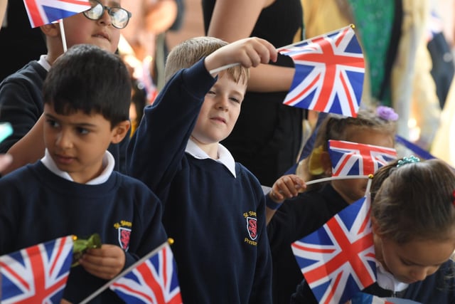 Youngsters welcome the Royal couple to the city