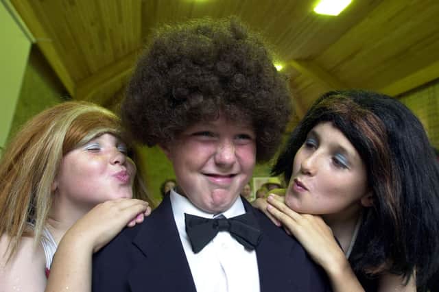 Gis a kiss.....Spice Girls, Josh Dickinson, 11 and Matthew Smith, 11, try to kiss Ben Jones, 11, during the year 6 leavers production of "Chaos at the Summer Fair" at Cop Lane CE School in Penwortham, near Preston