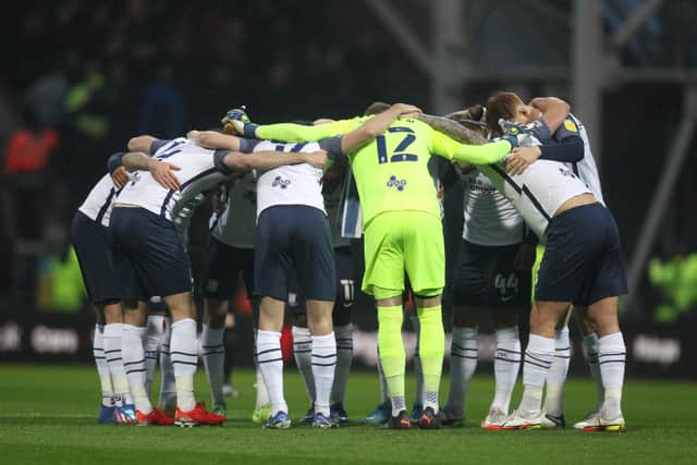 Preston North End players form a team huddle before the Blackpool game