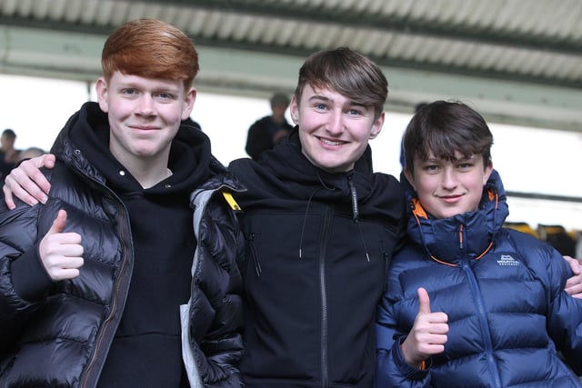 Three North End supporters in the away end at Derby