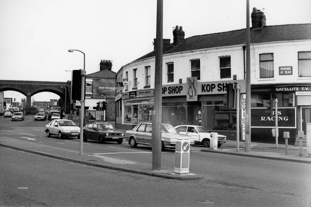 This picture would have been taken standing outside Umberto's Fish and Chip shop, or thereabouts. It shows cars waiting at traffic lights to travel either to Strand Road or on to Watery Lane