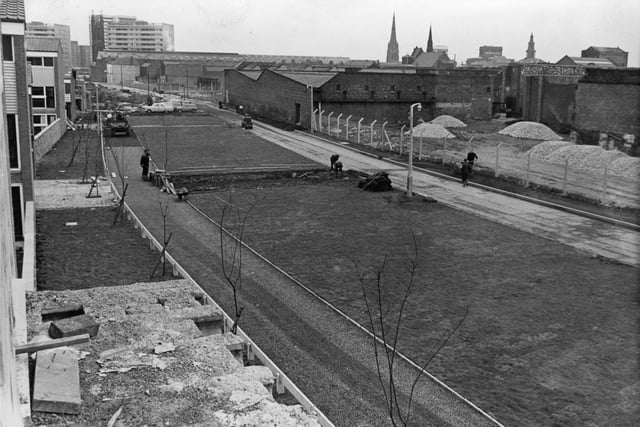 One of Preston's most remarkable face-lifting operations is going ahead in Queen Street, where Preston Corporation's 10,000th dwelling was opened when this image was taken in 1968. Alongside new blocks of maisonettes and flats, in what was formerly one of the town's least attractive thoroughfares, workmen are busily laying hundreds of square yards of turf and producing an "instant" village green