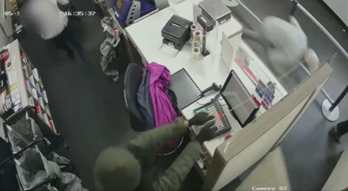 Watch shocking moment Post Office staff sprayed with ammonia as robbers make off with £15,000 in cash