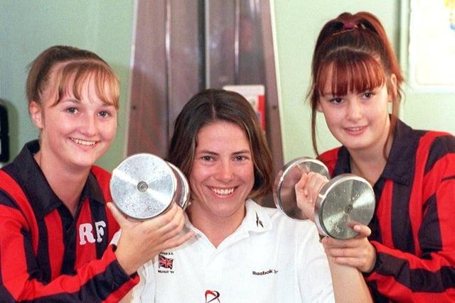 Great British athlete Helen Pattinson, from Preston, lifts some weights after opening the new fitness facilities at Lostock Hall High School, near Preston, helped by students Rachel Flynn and Rachael Vickers in 1999