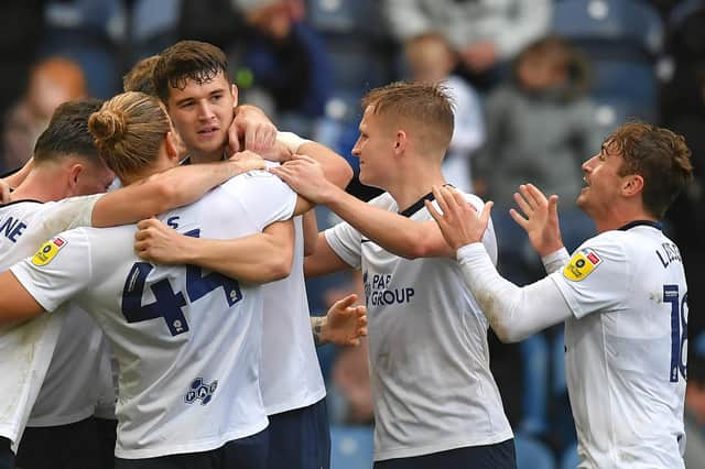 Preston North End's Jordan Storey is mobbed by team mates after scoring the winning goal.