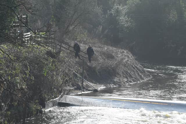 Police officers near the river Wyre as Lancashire Constabulary ramps up its efforts to find Nicola Bulley, who was last seen on Friday