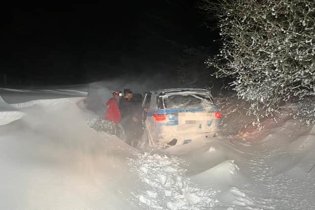 Mountain rescue teams had to "swim" through snow drifts to rescue the occupants of a stranded car who in east Lancashire (Credit: Rossendale & Pendle Mountain Rescue Team)