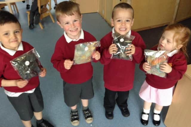 Left to Right: Zayn, Kaylem, Freddie and Aurora from Roseacre Primary School holding their souvenir alpaca fur