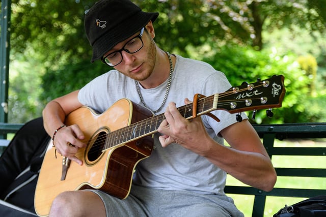 Marko Kis playing his guitar in Avenham Park
