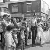 Veronica Merrifield makes merry with PC David Jackson on Emerson Road, as the Caribbean Carnival wended its way through the streets of Deepdale in Preston