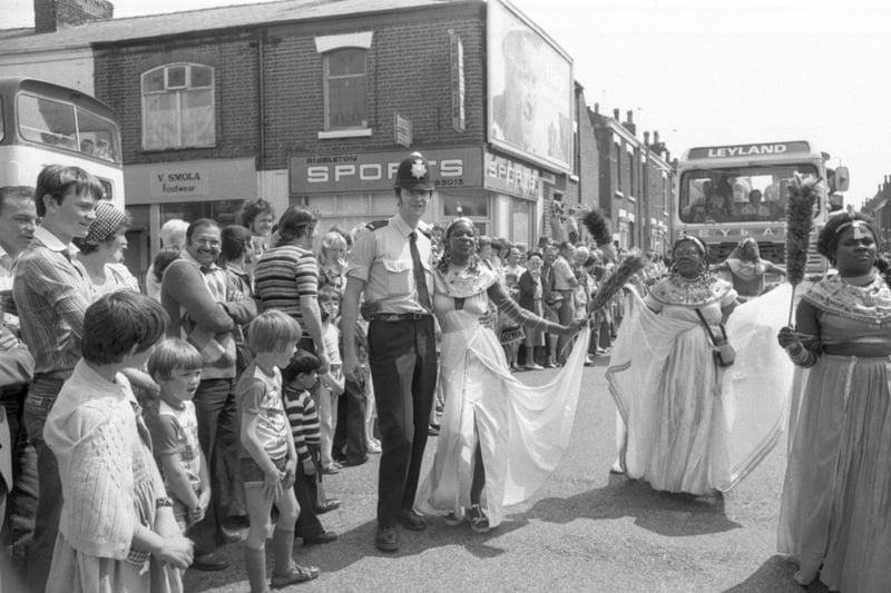 Veronica Merrifield makes merry with PC David Jackson on Emerson Road, as the Caribbean Carnival wended its way through the streets of Deepdale in Preston