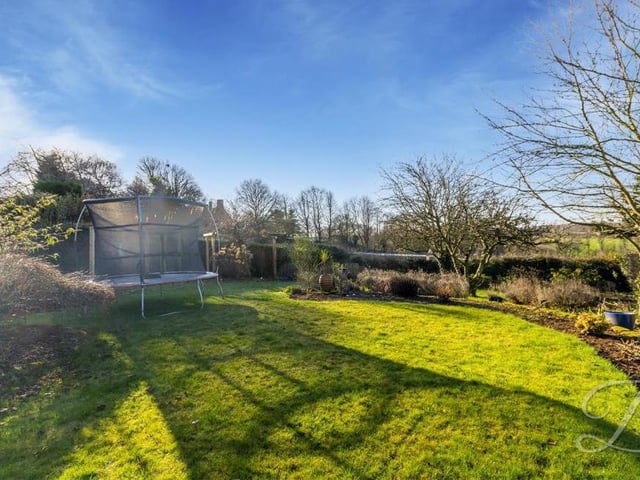 The back garden is delightfully presented and well maintained. It features a well established lawn, with planted borders.