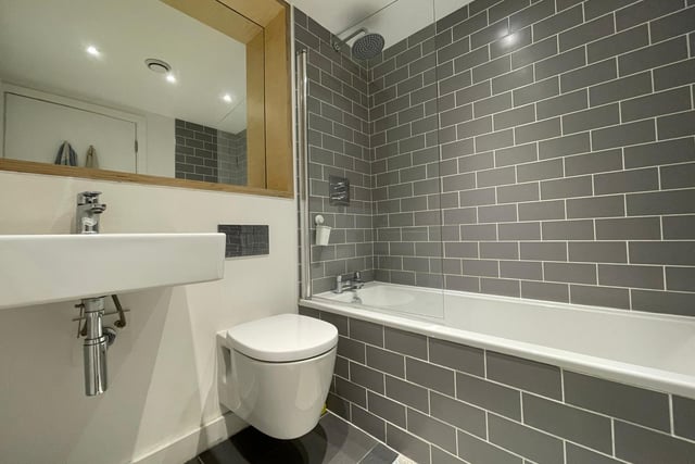 The bathroom is tastefully tiled and offers a shower, bath, sink and WC.
