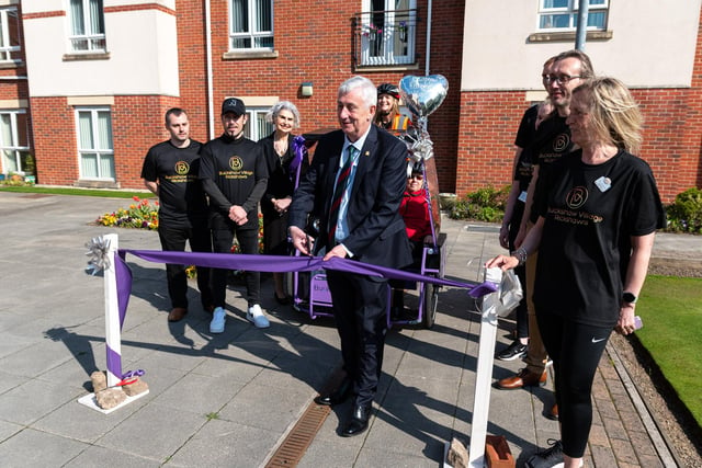 Sir Lindsay Hoyle cuts the ribbon at the launch of Rickshaw rides at Buckshaw Retirement Village