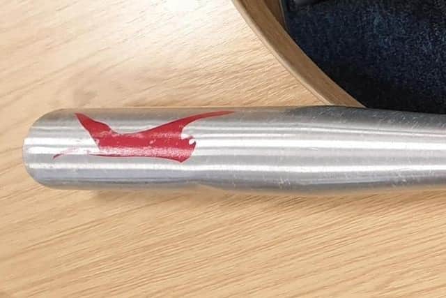 A metal baseball bat and drug paraphernalia were found hidden near a school in Preston. (Credit: Lancashire Police)